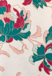 Tessuto floreale che presenta grandi peonie turchesi e borgogna su uno sfondo avorio, con texture morbide e eleganti steli curvi.