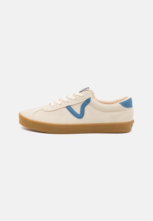 Beige suede sneaker featuring a blue leather accent and cream laces, with a gum rubber outsole and simple stitching detail.