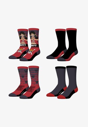 Quatre paires de chaussettes mi-hautes rouges et noires, deux avec des motifs de personnages d'anime et de crânes, deux uni avec orteils et talons rouges.
