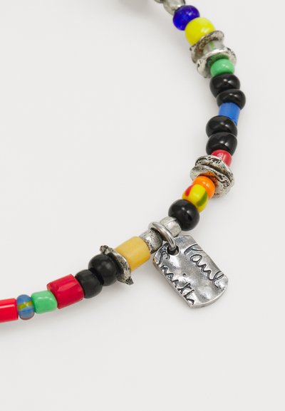 Colorful beaded necklace featuring a mix of black, red, blue, yellow, and green beads, accented with silver hardware and a tag.