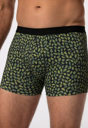 Boxers noirs et verts avec un motif de feuilles, en tissu extensible, et une taille noire avec le nom de la marque en relief pour un maintien sécurisé.