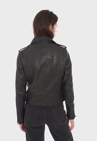 Black leather motorcycle jacket featuring a cropped design, double-breasted front, and detailed stitching. No visible hardware accents.