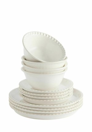 Stack of white ceramic bowls and plates with embossed dot pattern along edges on a white background.