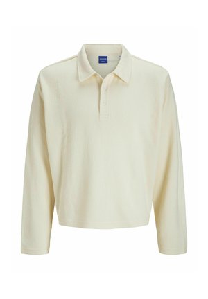 Lange mouw polo in romig beige geribbeld stof, met een kraag en drie knopen sluiting. Eenvoudige, relaxte pasvorm met rechte zoom.