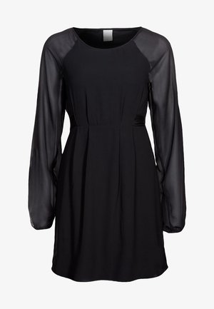 Black dress with long sheer sleeves, a round neckline, fitted bodice, and a flowing skirt. Made of smooth fabric, with a minimalist design.