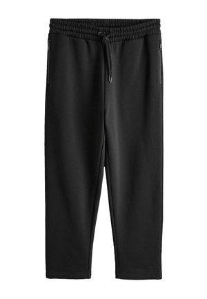 Sorte taperede sweatpants med elastisk talje, snøre og lynlåslommer i siden, vist fladt på hvid baggrund.