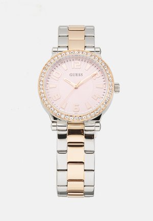 Silver and rose gold metal watch with a pink dial, round case, large numerals, and crystal accents around the bezel. Adjustable link bracelet.