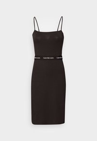 Svart ärmlös klänning med en figurnära passform, tillverkad av mjukt tyg. Har en kontrasterande vit midjeband från Calvin Klein Jeans.