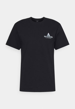 Camiseta negra de algodón. Presenta un cuello redondo, mangas cortas y un pequeño logo blanco en el pecho izquierdo con un diseño geométrico.