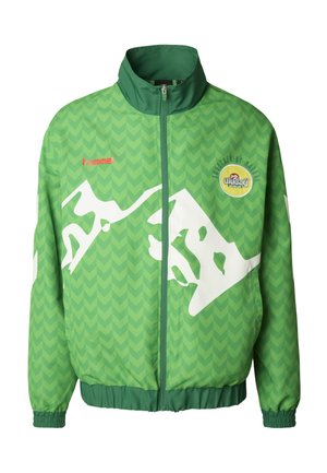 Vihreä tuulitakki, jossa on chevron-kuvio, valkoinen abstrakti kuvio, korkea kaulus ja logo vasemmalla puolella; joustavat hihansuut ranteissa.