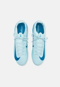 Light blue football shoes with a textured upper, contrasting dark blue Nike swoosh, and standard lacing system, featuring a padded collar.