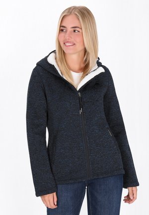 Textured navy-blue jacket with a zippered front and hood. Lined with white fleece, featuring side pockets and a casual fit.