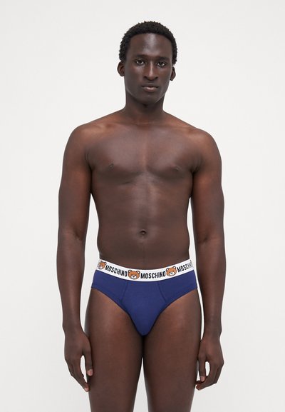 Navy blue brief with bear logo waistband, featuring a smooth cotton texture and a snug fit. Simple design, no additional patterns or accents.