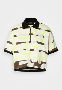 Short-sleeve polo shirt in a lightweight fabric featuring a bright yellow, brown, and gray abstract pattern, with a black collar and zip closure.