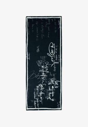 Mustast kangast sall, millel on valge käsitsi kirjutatud tekst ja abstraktsed mustrid, valge raamiga ääristatud. Sile tekstuur, ristkülikukujuline.