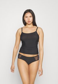 Black camisole with thin straps and a fitted design, paired with a matching black bikini bottom featuring mesh side panels.