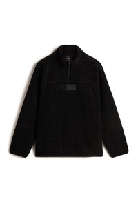 Sudadera de forro polar negra con cremallera de un cuarto, que presenta una superficie texturizada, un parche del logo de Vans en el pecho y dos bolsillos delanteros.