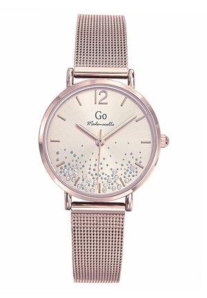 Montre ronde avec un bracelet en maille métallique en or rose, présentant un cadran crème clair orné de pierres précieuses et de chiffres arabes aux positions 12 et 6.