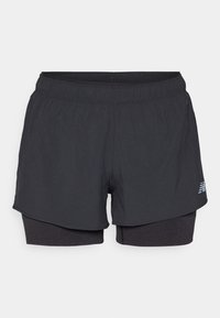 Black athletic shorts with an inner lining, featuring an elastic waistband, smooth texture, and a reflective logo on the side.