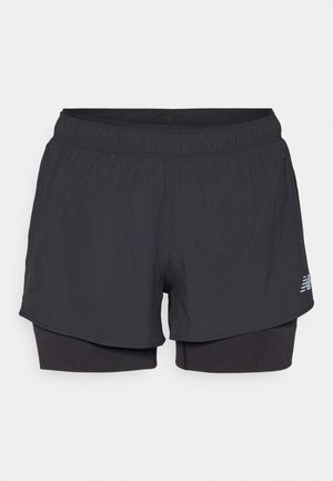 Black athletic shorts with an inner lining, featuring an elastic waistband, smooth texture, and a reflective logo on the side.