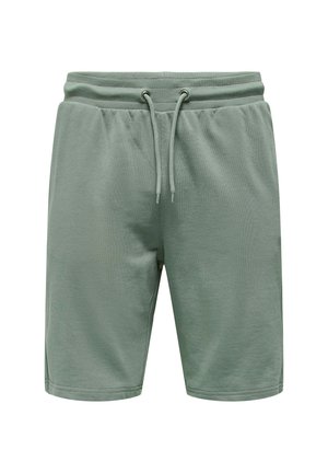 Light green cotton shorts with an elastic waistband, drawstring closure, and side slits for ease of movement. Smooth texture, casual design.