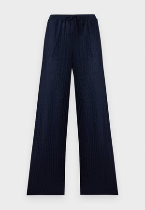 Σκούρο μπλε παντελόνι με φαρδιά μπατζάκια, διακριτική υφή ζιγκ-ζαγκ, ελαστική μέση και κλείσιμο με κορδόνι.