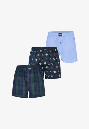 Drie herenboxershorts in blauw geruit, lichtblauw effen en marineblauw met kerstthema prints, overlappend gerangschikt.