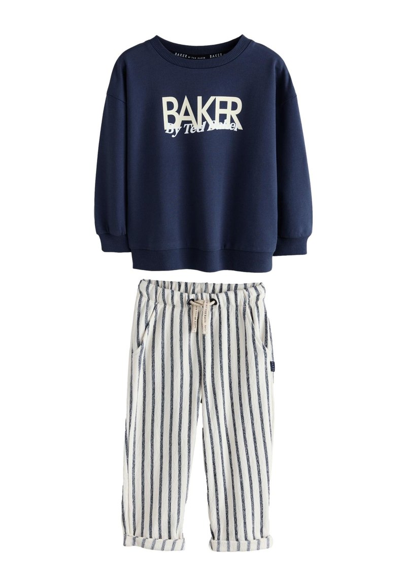 Marineblauwe sweatshirt met "BAKER" logo, gecombineerd met wit en marineblauw gestreepte broek met een trekkoord in de taille en opgerolde boorden.