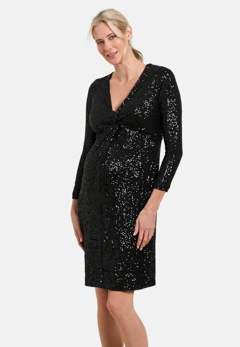 Schwarzes, knielanges Kleid mit langen Ärmeln, ausgestattet mit einem Bindeband in der Taille und bedeckt mit glänzenden Pailletten für eine strukturierte Optik.