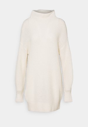 Pull-over en maille crème surdimensionné avec un col montant, des manches longues, une texture côtelée et une coupe décontractée, conçu pour le confort.