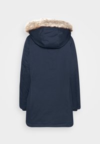 Manteau d'hiver bleu marine avec manches longues et capuche bordée de fausse fourrure marron clair, vu de dos.