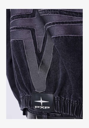Dark denim garment with a textured "V" design and elastic waistband. Features a black label with silver "PXP" logo and star accent.