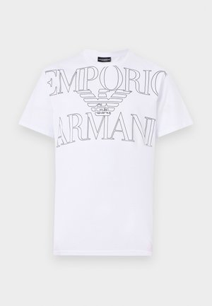 Valkoinen puuvillapaita, jossa on suuri musta Emporio Armanin logo siipimuotoilulla. Lyhyet hihat ja perinteinen crew neck -kaulus.