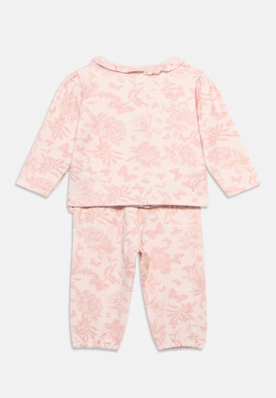 Completo composto da maglia a maniche lunghe rosa e pantaloni con motivo floreale e farfalle, caratterizzato da un colletto arricciato e polsini elastici ai pantaloni.