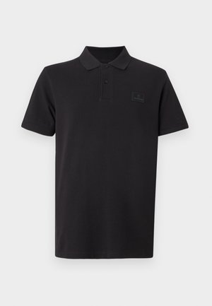 Polo nera in cotone con design classico, caratterizzata da un colletto, maniche corte e una discreta toppa con il logo Timberland.