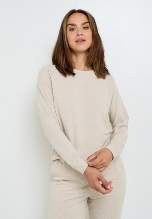 Maglietta beige a maniche lunghe e pantaloni coordinati realizzati in un tessuto morbido e testurizzato con cuciture minime e una vestibilità comoda. Adatta per un abbigliamento casual.