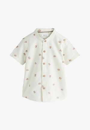 Kremasta kratkih rukava dječja majica s malim natisnutim licima medvjedića i drvenim gumbima sprijeda.