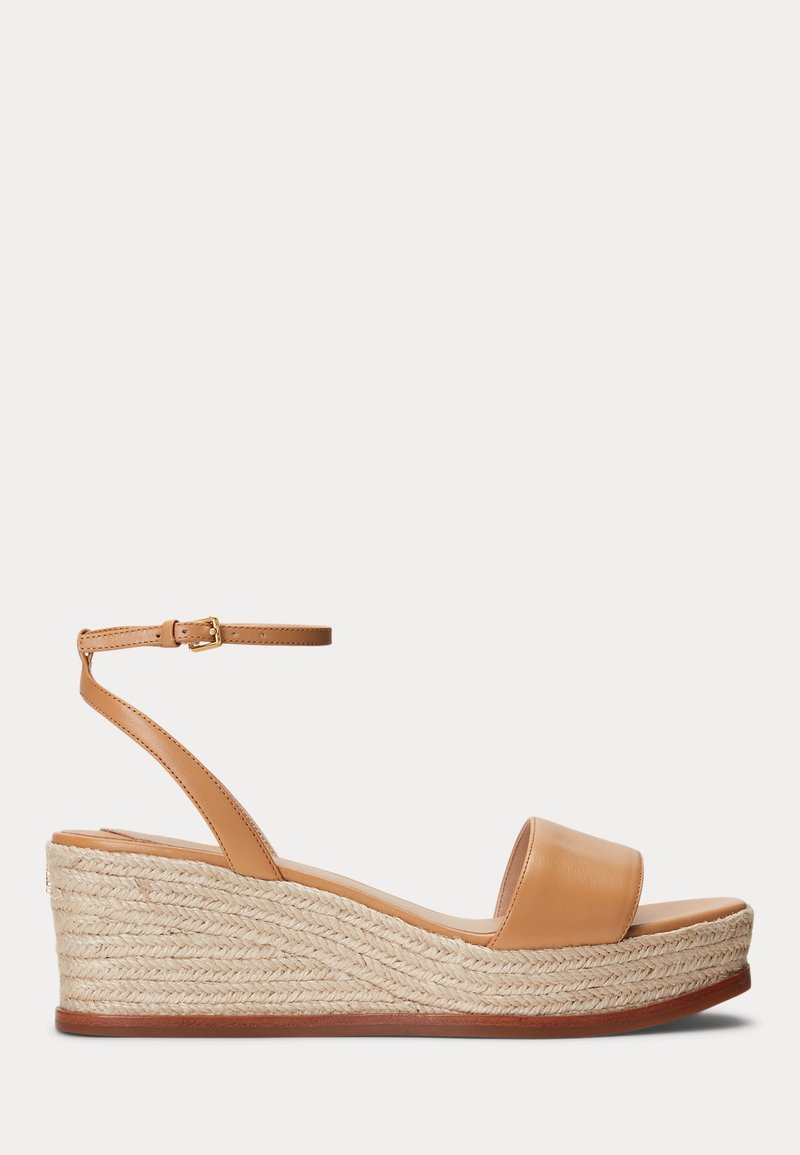 Tan leather wedge sandals with a woven jute platform, open toe, and adjustable ankle strap. Smooth texture with a natural finish.