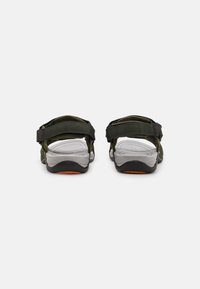 Sport sandals with green fabric straps and gray rubber soles. Features adjustable straps and a textured footbed for comfort.