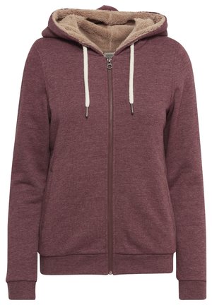 Felpa con zip color bordeaux, foderata in morbido pile beige, con cordini regolabili crema e polsini a coste. Presenta tasche laterali e una vestibilità comoda.