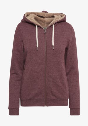 Burgundski zip-hoodie s mekim, bež flisom, podesivim vrpcama u krem boji i rebrastim manžetama. Ima bočne džepove i opušteni kroj.