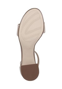 Beige-sandaalin pohja, jossa on sileä pinta, varustettuna teksturoitulla kumikannalla ja erottuvalla Clarks-logolla. Suunniteltu ainutlaatuisella kuviolla.