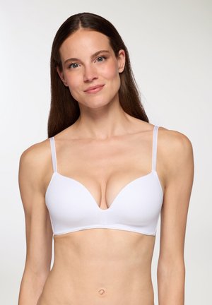 Reggiseno bianco con scollatura profonda, spalline sottili regolabili, texture del tessuto liscia e design senza cuciture. Nessuna minuteria o motivo visibile.