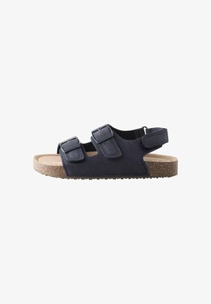 Navy blue open-toe sandal with two adjustable buckles and a back strap, cork footbed, and rubber sole.
