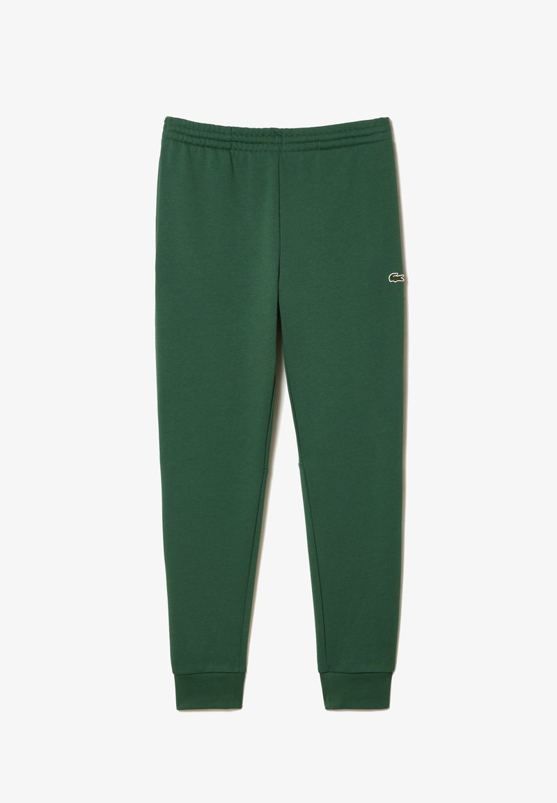 Grüne Baumwoll-Jogginghosen mit elastischem Bund und Bündchen. Merkmale ein kleines weißes Logo am linken Bein. Glatte Textur, taillierte Passform.