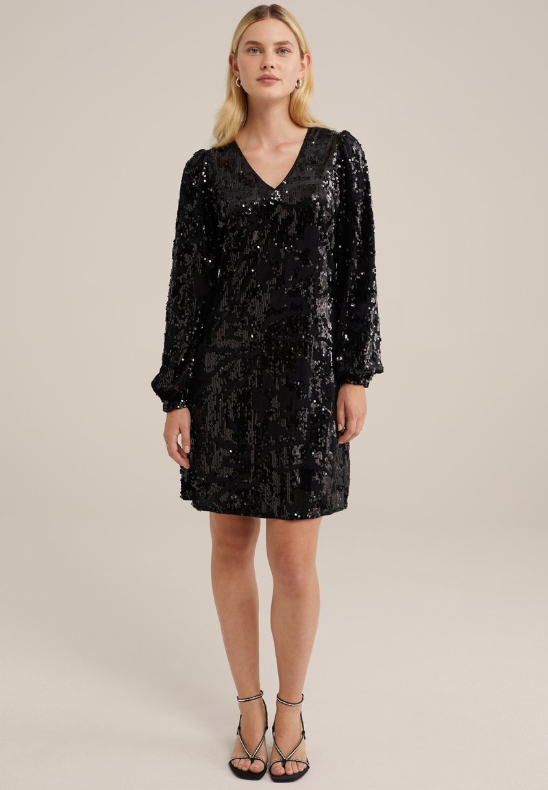 Schwarzes Pailletten-Kleid mit V-Ausschnitt, langen Puffärmeln und entspannter Passform, das eine strukturierte Oberfläche und einen knielangen Saum hat. Verstellbare Träger.