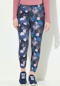 Leggings blu navy con un motivo colorato di cerchi in rosa, blu e grigio, realizzati in un tessuto liscio ed elastico e con un design lungo fino alla caviglia.