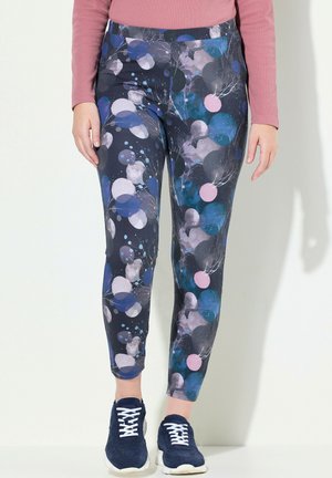 Leggings blu navy con un motivo colorato di cerchi in rosa, blu e grigio, realizzati in un tessuto liscio ed elastico e con un design lungo fino alla caviglia.