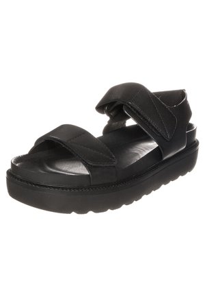 Sort lædersandal med tykk sål, to brede justerbare remme over foden og rundt om anklen samt polstret fodseng.