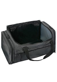 Sac de voyage noir avec un extérieur lisse, doté de compartiments zippés, de poignées doubles et d'un intérieur spacieux avec une doublure grise.